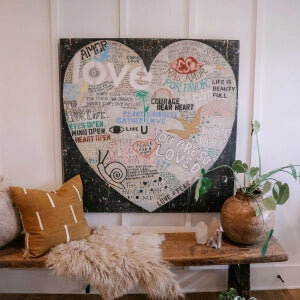 A heart-shaped canvas adorned with meaningful words.