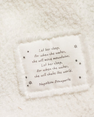 A white blanket with a poem written on it, adding a touch of elegance and literary charm.