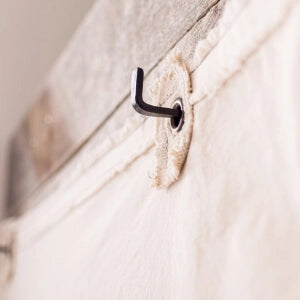 A detailed view of a curtain hook, showcasing its intricate design and functionality.