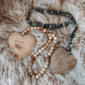 Wooden heart necklace with colorful beads, a charming accessory that adds a touch of warmth and style.