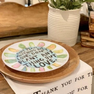 Thank you plate with a beautifully arranged assortment of colorful flowers and a handwritten note expressing gratitude.