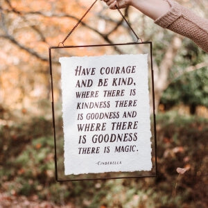 Inspiring message of 'have courage and be kind' written in bold letters on a white background.