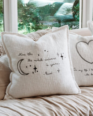 Two pillows adorned with hearts and stars, adding a touch of love and whimsy to any space.