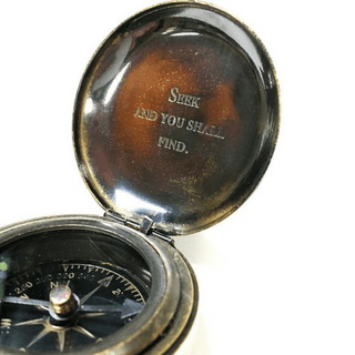  open compass with the phrase "seek and you shall find" engraved