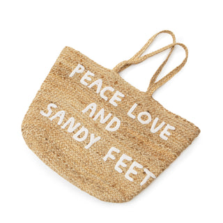 jute tote bag with two handles and white embroidery reading "peace love and sandy feet"