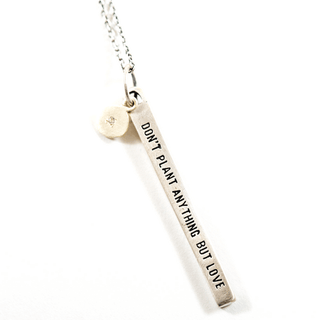  sterling silver necklace with the quote "don't plant anything but love"