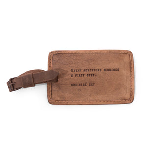 brown leather luggage tag with the quote "Every adventure requires a first step."