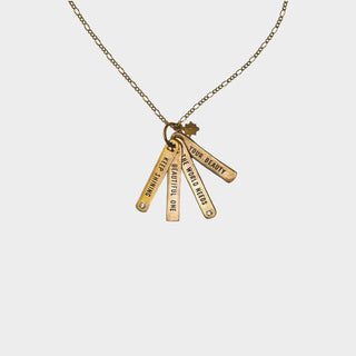  brass necklace with the quote "keep shining beautiful one the world needs your beauty"