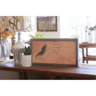 This print features a dark bird on a tan/orange background saying "Enjoy yourself. It's later than you think."