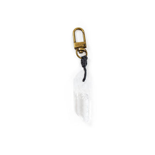 A white crystal point keychain that has black threading and a gold clasp.