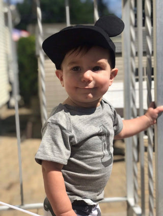 little boy wearing the number 1 shirt